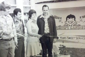 © J. Smith John R. Smith and his wife Shirley cutting the ribbon for the opening of the new Smith's Candies warehouse and retail store.
